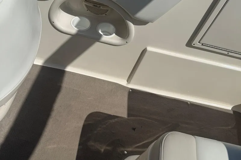 Slide: The Image of Interior of a 2005 Bryant 214 boat showing cup holders and seating area. - 28