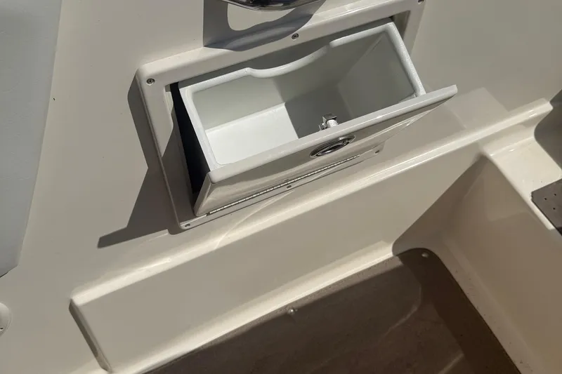 Slide: The Image of Open storage compartment on a 2005 Bryant 214 boat, showing interior details. - 29