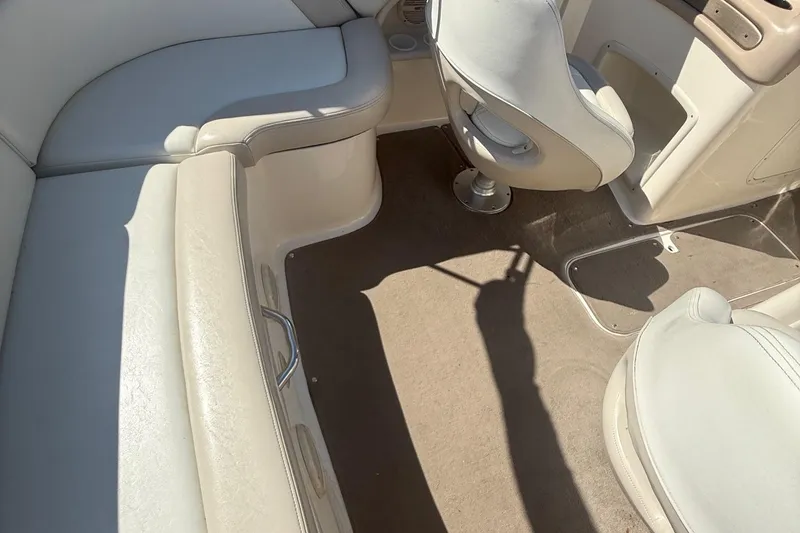 Slide: The Image of Interior of a 2005 Bryant 214 boat with beige seating and carpet. - 31