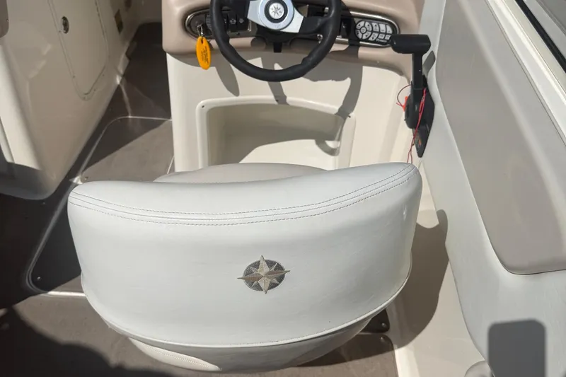 Slide: The Image of Captain's seat and steering wheel of a 2005 Bryant 214 boat. - 8