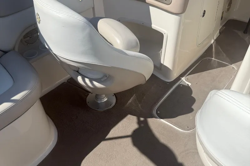 Slide: The Image of Interior of a 2005 Bryant 214 boat with white seating and carpeted floor. - 9