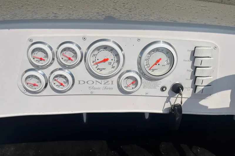Slide: The Image of Dashboard of a 1999 Donzi 22 Classic boat with gauges and switches. - 11