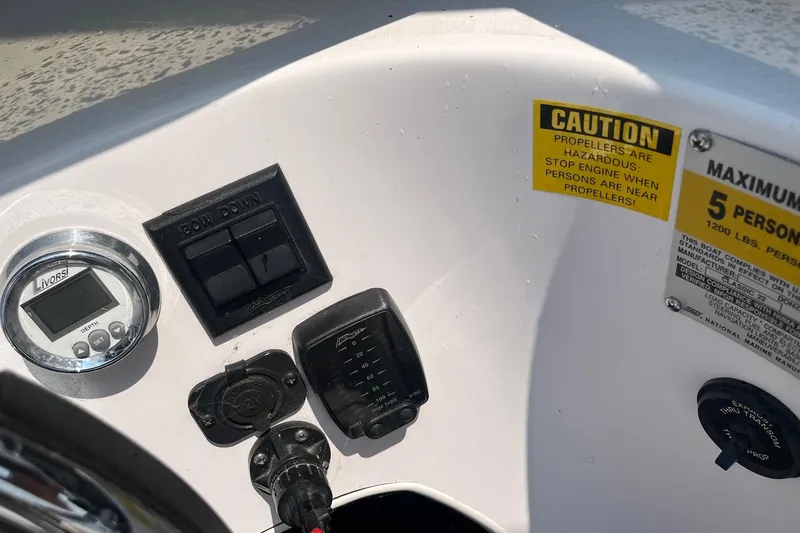 Slide: The Image of Control panel of a 1999 Donzi 22 Classic boat with caution labels and gauges. - 14