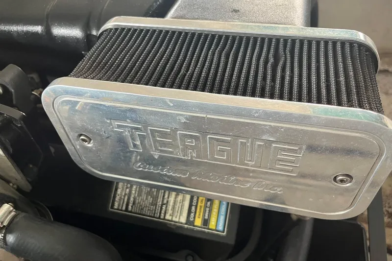 Slide: The Image of Air filter of a 1999 Donzi 22 Classic boat engine, featuring Teague Custom Marine branding. - 21