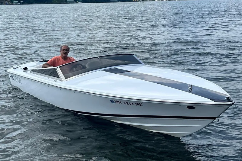 Slide: The Image of 1999 Donzi 22 Classic boat on water with driver in orange shirt. - 5