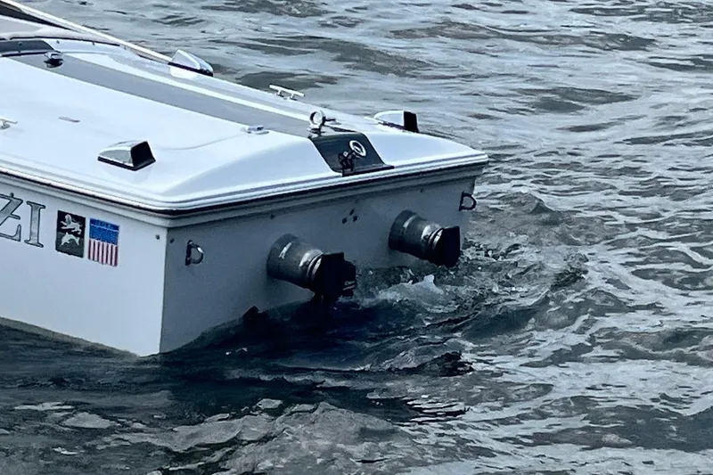 Slide: The Image of 1999 Donzi 22 Classic boat stern in water, showcasing dual exhausts. - 8