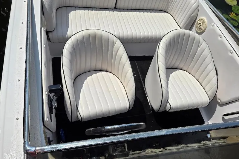 Slide: The Image of 1999 Donzi 22 Classic boat interior with white cushioned seats and sleek design. - 9