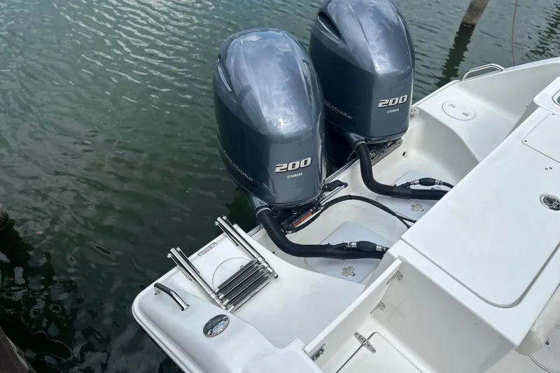 Slide: The Image of 2014 Sea Hunt Gamefish 27 with twin Yamaha 200 engines on calm water. - 10