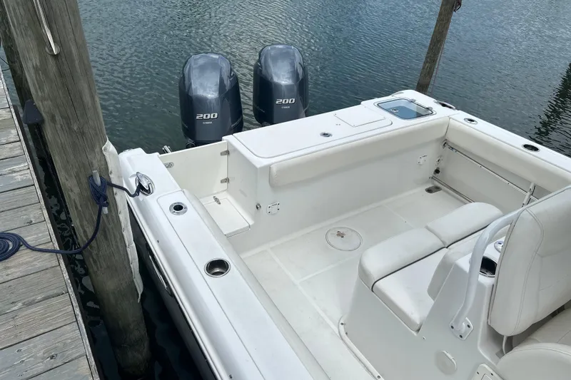 Slide: The Image of 2014 Sea Hunt Gamefish 27 boat with twin 200 horsepower engines docked at marina. - 14