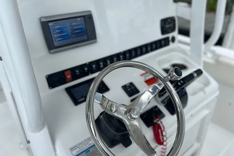 Slide: The Image of Steering console of 2014 Sea Hunt Gamefish 27 boat with navigation controls. - 18