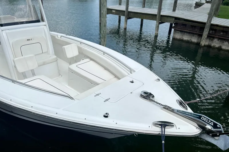 Slide: The Image of 2014 Sea Hunt Gamefish 27 boat docked on calm water. - 26