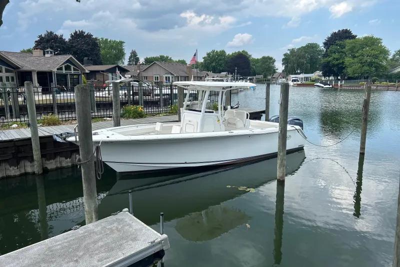 Slide: The Image of 2014 Sea Hunt Gamefish 27 boat docked in a serene marina setting. - 3
