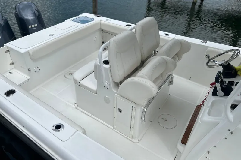 Slide: The Image of 2014 Sea Hunt Gamefish 27 boat interior with dual seats and steering console. - 5