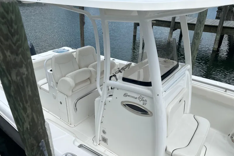 Slide: The Image of 2014 Sea Hunt Gamefish 27 boat interior with white seating and console. - 6