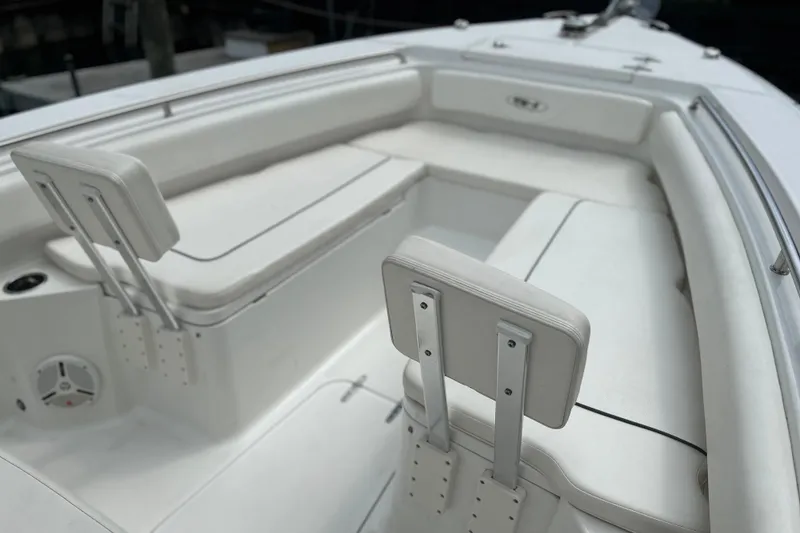 Slide: The Image of 2014 Sea Hunt Gamefish 27 boat interior with white cushioned seating. - 7