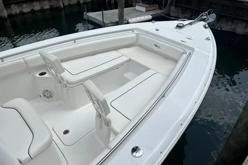 Slide: The Image of 2014 Sea Hunt Gamefish 27 boat interior with white seating and stainless steel railings. - 9