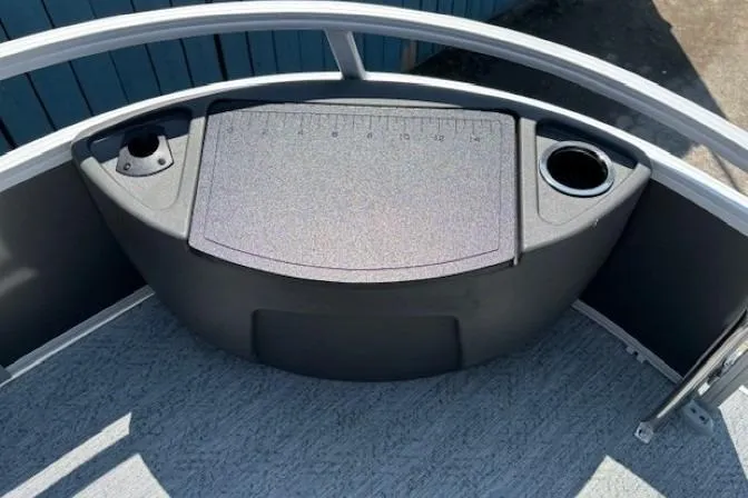 Slide: The Image of 2026 Sun Tracker Bass Buggy 18 DLX boat deck with cup holders and measurement board. - 10