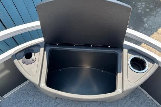 Slide: The Image of 2026 Sun Tracker Bass Buggy 18 DLX storage compartment with cup holders, open lid view. - 11