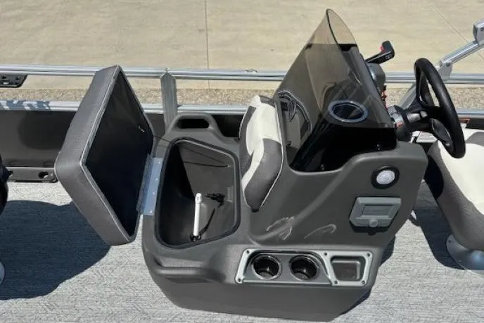 Slide: The Image of 2026 Sun Tracker Bass Buggy 18 DLX boat console with storage compartment and steering wheel. - 16