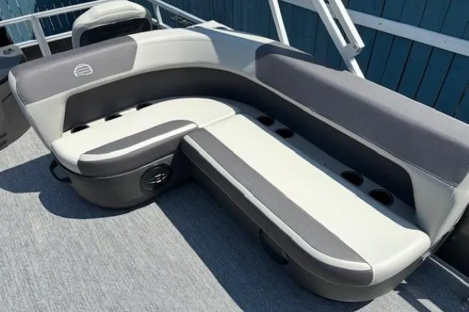 Slide: The Image of 2026 Sun Tracker Bass Buggy 18 DLX boat seating with cup holders and gray upholstery. - 17