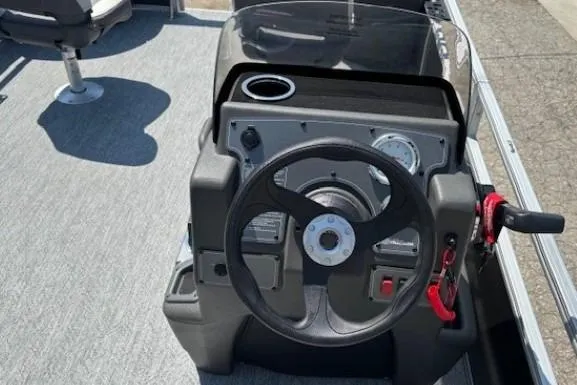 Slide: The Image of 2026 Sun Tracker Bass Buggy 18 DLX steering console with modern controls and cup holder. - 20