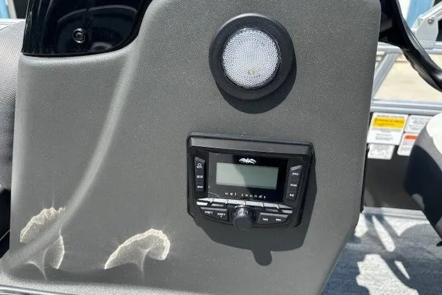 Slide: The Image of 2026 Sun Tracker Bass Buggy 18 DLX dashboard with speaker and control panel. - 22