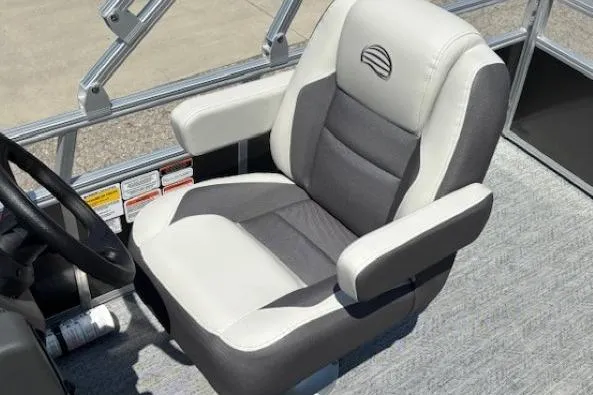 Slide: The Image of 2026 Sun Tracker Bass Buggy 18 DLX captain's chair, featuring gray and white upholstery. - 23