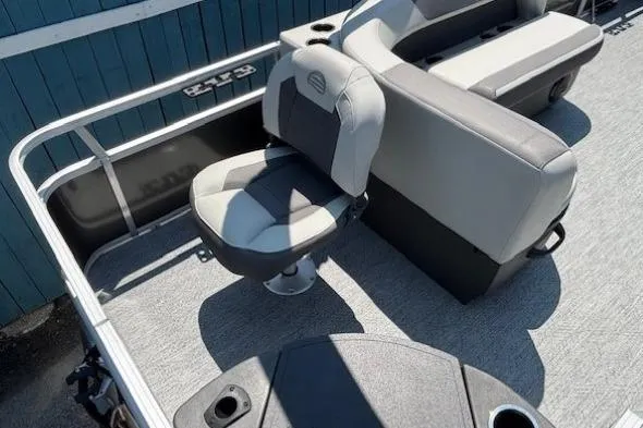 Slide: The Image of 2026 Sun Tracker Bass Buggy 18 DLX interior with seating and console. - 26