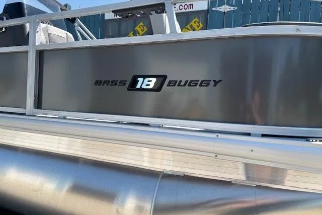 Slide: The Image of 2026 Sun Tracker Bass Buggy 18 DLX pontoon boat side view with logo. - 5