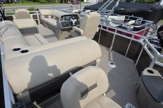 Slide: The Image of 2025 Sun Tracker Sportfish™ 20 DLX pontoon boat with beige seating and modern helm. - 11