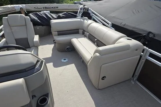 Slide: The Image of 2025 Sun Tracker Sportfish™ 20 DLX pontoon boat with beige seating and spacious deck layout. - 12