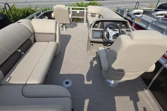 Slide: The Image of 2025 Sun Tracker Sportfish™ 20 DLX pontoon boat interior with beige seating and steering console. - 14