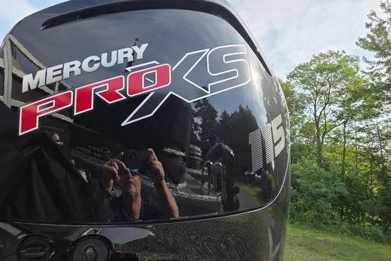 Slide: The Image of Mercury Pro XS 115 engine on 2025 Sun Tracker Sportfish™ 20 DLX, outdoors with trees. - 15