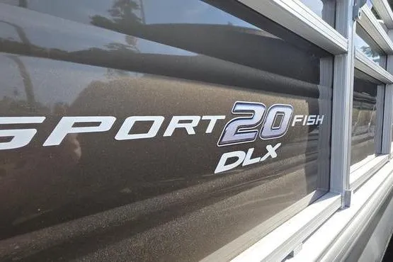 Slide: The Image of 2025 Sun Tracker Sportfish™ 20 DLX boat logo on dark exterior. - 3