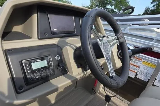 Slide: The Image of 2025 Sun Tracker Sportfish™ 20 DLX boat dashboard with steering wheel and control panel. - 4