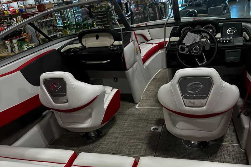 Slide: The Image of 2024 Crownline 200SS boat interior with white and red seating, modern dashboard, and steering wheel. - 4