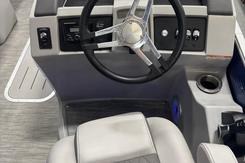 Slide: The Image of 2020 Bennington 23 SXPD boat dashboard with steering wheel and controls. - 12