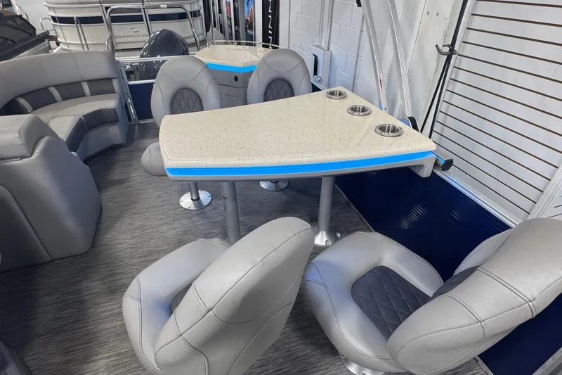 Slide: The Image of 2020 Bennington 23 SXPD boat interior with modern seating and table setup. - 13