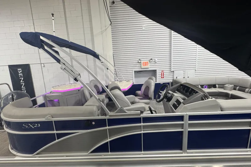 Slide: The Image of 2020 Bennington 23 SXPD pontoon boat with blue canopy and luxurious seating. - 4