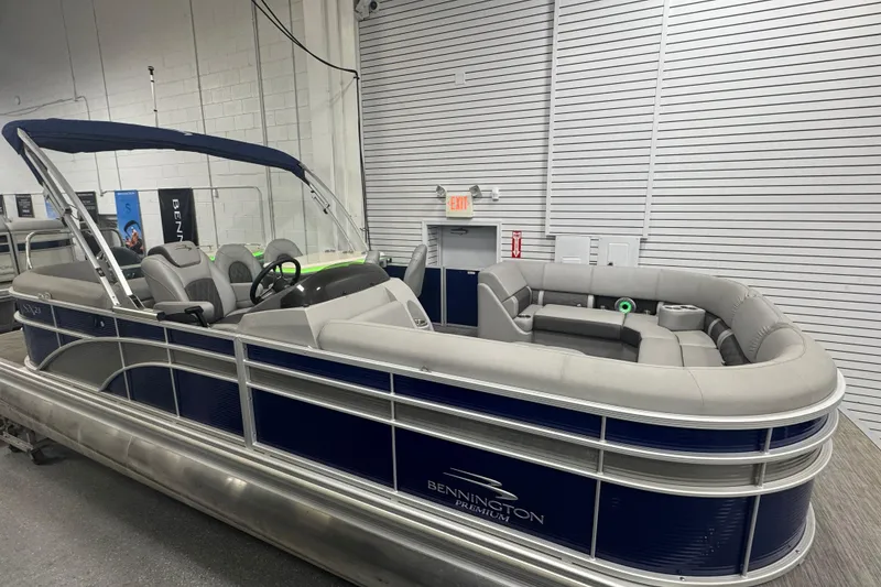 Slide: The Image of 2020 Bennington 23 SXPD pontoon boat with blue and gray seating in a showroom. - 5