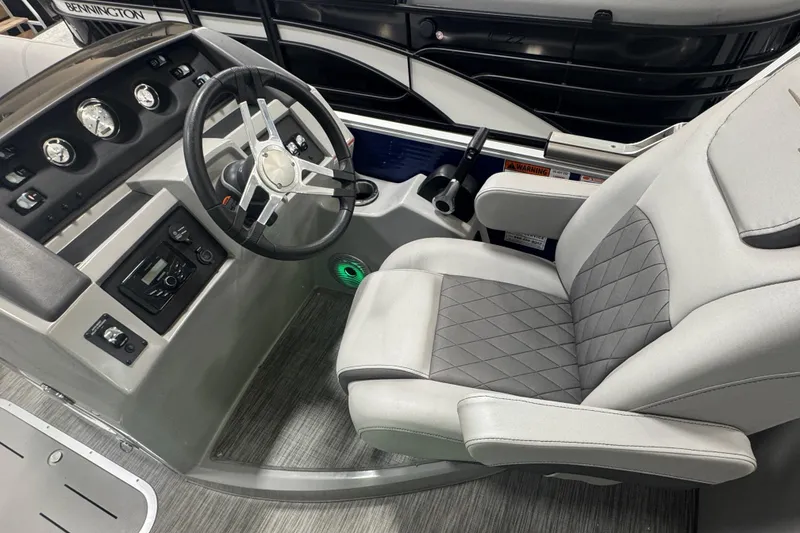 Slide: The Image of 2020 Bennington 23 SXPD boat interior with steering wheel and captain's chair. - 9