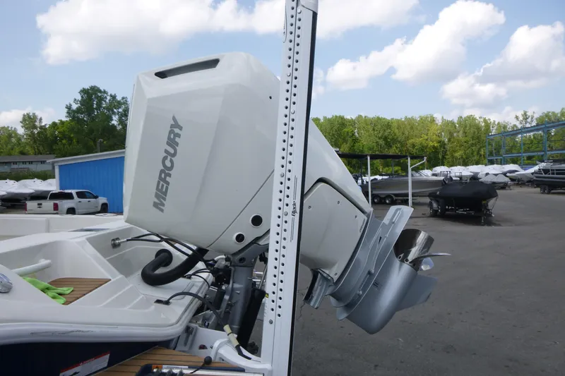 Slide: The Image of 2024 Ranger 2660 Bay boat with Mercury outboard motor in a marina setting. - 17