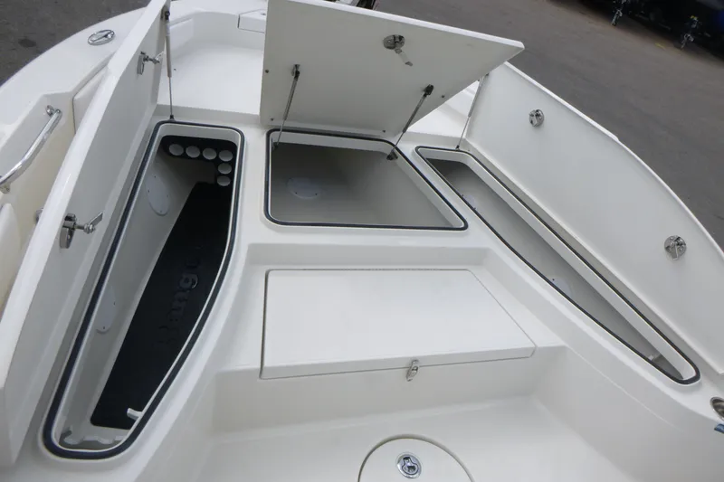 Slide: The Image of 2024 Ranger 2660 Bay boat storage compartments with open hatches, showcasing spacious design. - 8