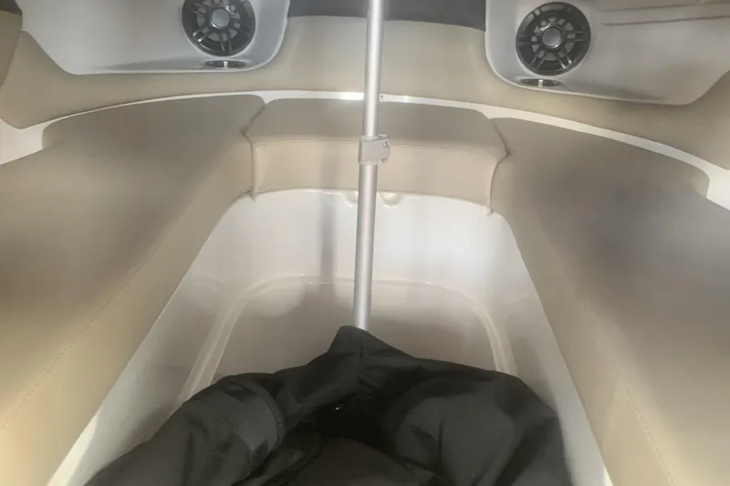 Slide: The Image of Interior of 2019 Rinker 29 QX boat with beige seating and speakers. - 10