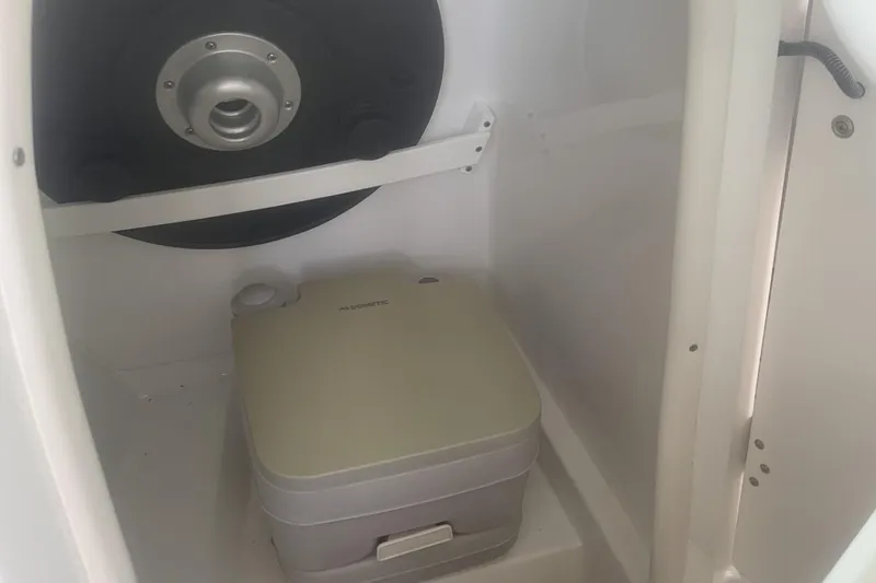 Slide: The Image of Portable toilet inside 2019 Rinker 29 QX boat cabin. - 11