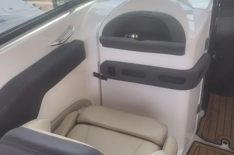Slide: The Image of Interior of 2019 Rinker 29 QX boat with beige seating and sleek design. - 12
