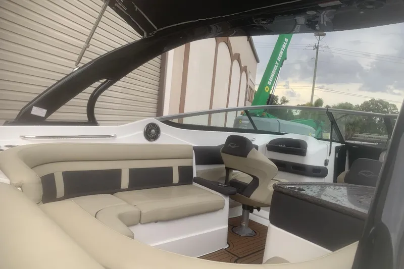 Slide: The Image of 2019 Rinker 29 QX boat interior with beige seating and modern design. - 16