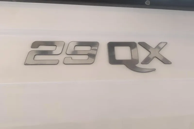 Slide: The Image of Chrome '29 QX' emblem on 2019 Rinker boat exterior. - 4