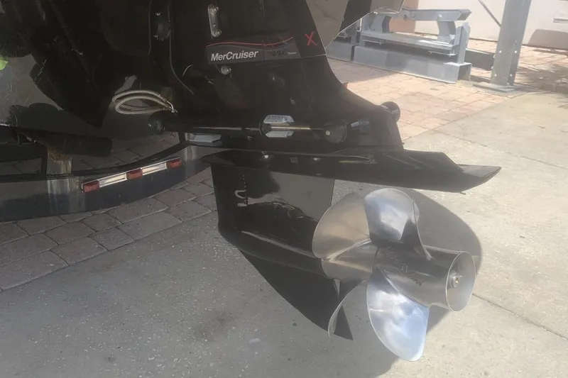 Slide: The Image of 2019 Rinker 29 QX boat with MerCruiser outdrive and stainless steel propeller. - 6