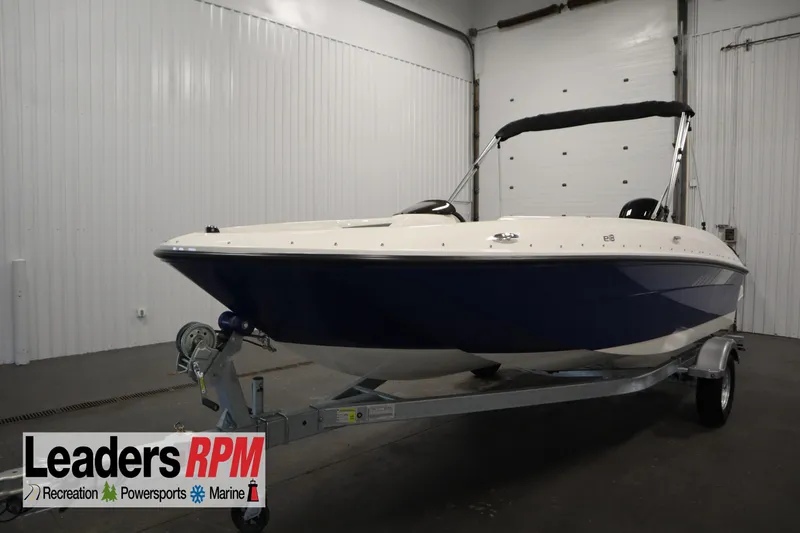 The Image of 2026 Bayliner Element E18 boat on trailer in indoor showroom. - 0